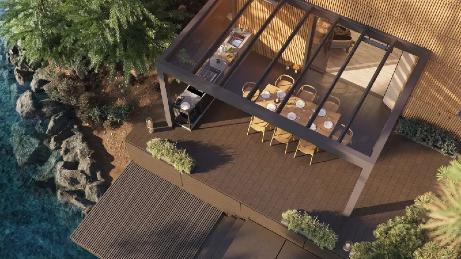 Eine Terrassenüberdachung Glas von einem Holzhaus, welches an einen Steg gelegen ist.